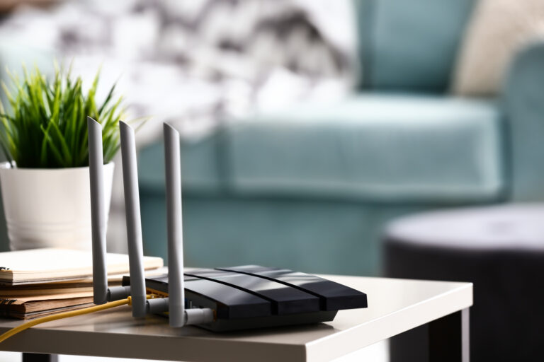 Router sitting on a desk with lounge if the background